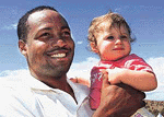 Brian Lara holds Wednesday Pyle (age 1) before the Northern Territory Invitation XI cricket match in Alice Springs on Tuesday.