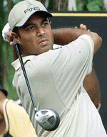 India's Arjun Atwal plays a shot at the 9th hole during the second round of the Johnnie Walker Classic 2000 tournament at the alpine course near Bangkok on Friday. 