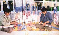 Finishing touches being given to cricket bats at a unit in  Sangam