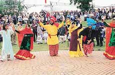 Indian participants performing jhoomar at the Llangollen international music and dance festival at North Wales. 