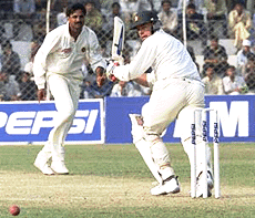 Zimbabwes captain Heath Streak (right) watches the ball after a shot of bowler Javagal Srinath during the first day play of first Test match in New Delhi on Saturday.
