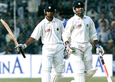 Indian cricket captain Saurav Ganguly (R) comes out of the ground with team-mate Rahul Dravid after winning the first Test match against Zimbabwe in New Delhi on Wednesday.