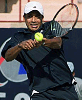 India's Mahesh Bhupati returns a shot to China's Wang Yu during their men's singles match of Asia Cup Tennis Tournament in New Delhi.