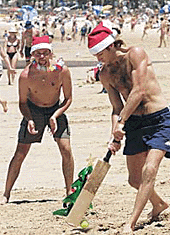 Tourists from the Britain Joc Squire (left) and Lee Edwards play beach cricket on Manly Beach in Sydneys northern suburburbs on Christmas Day.