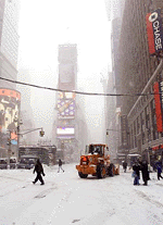 A small number of people and a snow plough occupy New York's Times Square, on Saturday.