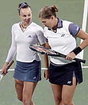 Switzerlands Martina Hingis (left) and Monica Seles of the USA chat between points during their first round doubles match.