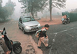 Weighed down by the heavy school bag and the chill, a boy on his way to school.