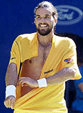 Australias Pat Rafter rips his shirt off as he celebrates his fourth round win over Great Britains Tim Henman at the Australian Open in Melbourne on Sunday. 