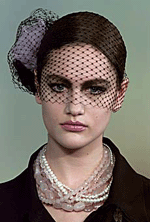 A model presents a lace head dress and a pearl necklace as part of Chanels 2001 Spring-Summer high fashion collection in Paris on Tuesday. 
