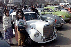 Members of a family stand next to their modified Beetle during a rally of Volkswagen cars of the 1960s in Dhaka on Saturday.