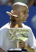 The USA's Andre Agassi holds the winners trophy after Agassi won the men's singles final against Arnaud Clement from France at the Australian Open Tennis Championships in Melbourne on Sunday.