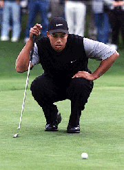 Tiger Woods lines up a putt on the 13th green at the Poppy Hills golf course during the second round of the AT & T Pebble Beach National Pro-Am Golf Tournament on Friday.