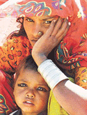 A woman waits for relief supplies with her son at a relief camp in Khavda, Gujarat, where some 30,000 persons were killed by the January 26 quake.