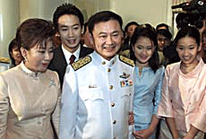 Thailands new Prime Minister Thaksin Shinawatra (centre) and his family pose for group pictures after he received a royal decree from King Bhumibol Adulyadej appointing him as Prime Minister in Bangkok on Friday. 