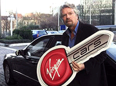 The Virgin group Chairman, Sir Richard Branson, poses with a Virgin car key after a news conference in Brussels on Wednesday.