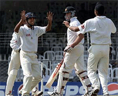 India A cricketers Harbhajan Singh (R) and Hemang Badani (L) celebrate the dismissal of Australian batsman Mathew Hayden (C) on the final day of the three-day tour match between the two teams in Nagpur on Monday. 