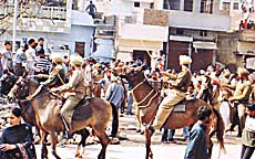 A police contingent, including mounted cops, during the anti-encroachment drive in Ludhiana on Friday.