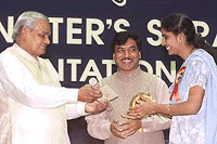 Prime Minister Atal Behari Vajpayee hands a Shram Award to Padmashree SK (R) , while Union Labour Minister Satyanarayan Jatiya (C) looks on during a ceremony in New Delhi on Saturday. 