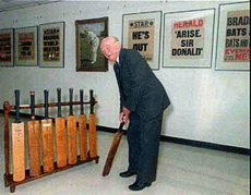 Australian cricket legend Sir Donald Bradman poses with a bat in Adelaide, Australia, in this May 1996 file photograph after he gave his first exclusive interview to a TV channel on his 87th birthday.