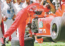 Defending world champion Michael Schumacher inspects his Ferrari after he remained uninjured from a crash in which he rolled his car during a practice session at the Australian Grand Prix in Melbourne on Friday.