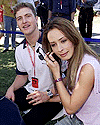 Ralf Schumacher of Germany sits with his girlfriend Cora Brinkman behind his Williams pit garage at the Australian Formula One Grand Prix in Melbourne on Saturday.