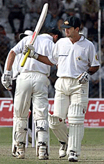 Australian batsman Ricky Ponting raises his bat to acknowledge his century during the first days play of the three-day tour match between Indias Board President XI and the Australian team in New Delhi on Tuesday. 