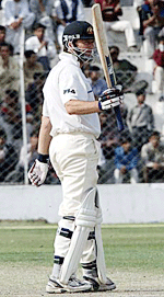 Australian cricket captain Steve Waugh raises his bat on completing a century during the first days play of the three-day tour match between the Board President XI and the Australian team in New Delhi on Tuesday.