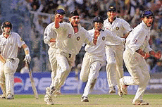 Captain Saurav Ganguly along with Indias main wicket-taker Harbhajan Singh jumps in the air with joy as fellow teammates join in the celebrations.