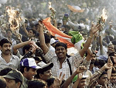 Indian supporters celebrate with burning papers