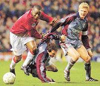 FC Bayern Munichs Stefan Effenberg (R) and Thomas Linke are pushed away by Manchester Uniteds Andy Cole during the quarterfinal of the UEFA Champions League match at Manchester on Tuesday. 