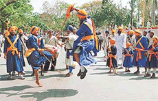 Nihangs give a demonstration of martial art Gatka during a procession taken out in Chandigarh on Saturday.