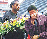 World heavyweight boxing champion Lennox Lewis from Britain carrying a wreath joins those remembering those who died at the Johannesburgs Ellis Park soccer stadium on Sunday. 