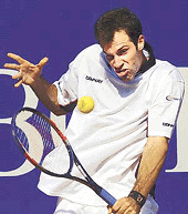 Greg Rusedski of Great Britain returns the ball to Andrei Pavel of Romania during the first round of the Monte Carlo Open in Monaco on Tuesday.