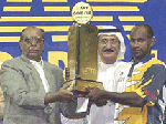 Sri Lanka's captain Sanath Jayasuriya receives the trophy from Jan Mohammad, the Chairman of ARY Pakistan (L) as Mohammad Redha Abbas, member of Emirates Cricket Boards (C) looks after the final which Sri Lanka won by 77 runs, on Friday.