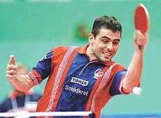 Jean-Phillipe Gatien of France returns the ball against Belarus Evgeni Chtchetinne during the mens team events of the 46th World Table Tennis Championships in Osaka