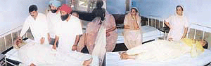 Sardul Singh of Nabipur village lies in Civil Hospital, Fatehgarh Sahib, on Sunday, after he was injured by robbers and (right) Sarduls daughter, also in the hospital.