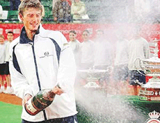 Spains Juan Carlos Ferrero sprays champagne in celebration after winning the Barcelona Open final against compatriot Carlos Moya on Sunday. 