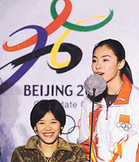 Chinese Olympic champion gymnast Liu Xuan (R) and former team-mate Song Lan (L), who was disabled during competition at the Goodwill Games in the USA attend an extravaganza in Beijing to promote the Chinese capital's 2008 Olympic bid on Tuesday.