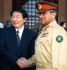 Pakistan's military ruler Gen Pervez Musharraf receives Chinese Prime Minister Zhu Rongji at the Pakistan Air Force base in Islamabad on Friday.
