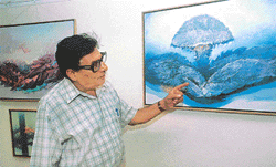 Artist Baldev Gambhir explains his painting titled, Emergence of life, at IndusInd Gallery in Sector 8, Chandigarh, on Saturday.