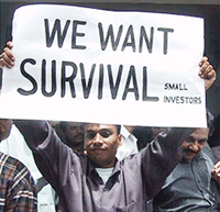 A Pakistani investor holds a placard in front of the Karachi Stock Exchange on Monday. 