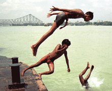 Indian boys jump into the Ganga river to get some relief from the 40 degrees Celsius heat, in Calcutta, on Thursday. 