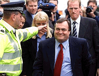 Britains Deputy Prime Minister John Prescott (right) is escorted by the police as he arrives at the Prestonpans Labour Club in Scotland on Thursday. 