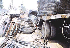 Vehicles lie crushed under rolls of steel wires near Dhandari Kalan main level crossing in Ludhiana on Thursday.