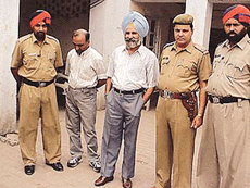 XEN Daljit Singh and Ashok Gupta in custody of the Division Number 5 police in Ludhiana on Sunday.