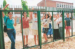 From behind the fence of the GCG hostel in Sector 11, Chandigarh, girls peer at the world outside. 