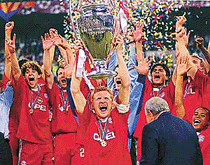 Bayern Munich captain Stefan Effenberg holds up the Champions League trophy at the San Siro Stadium in Milan, Italy, on Wednesday.