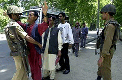 Indian paramilitary troopers check pedestrians in Srinagar on Friday. 