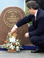 Britain's Prime Minister Tony Blair lays a floral tribute at the memorial of police constable Raj Ahmed in Manchester on Saturday.