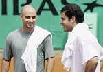 USAs Andre Agassi (left) and Pete Sampras chat between their respective training sessions on the Roland Garros Suzanne Lenglen court in Paris on Saturday. The French Open starts next Monday.